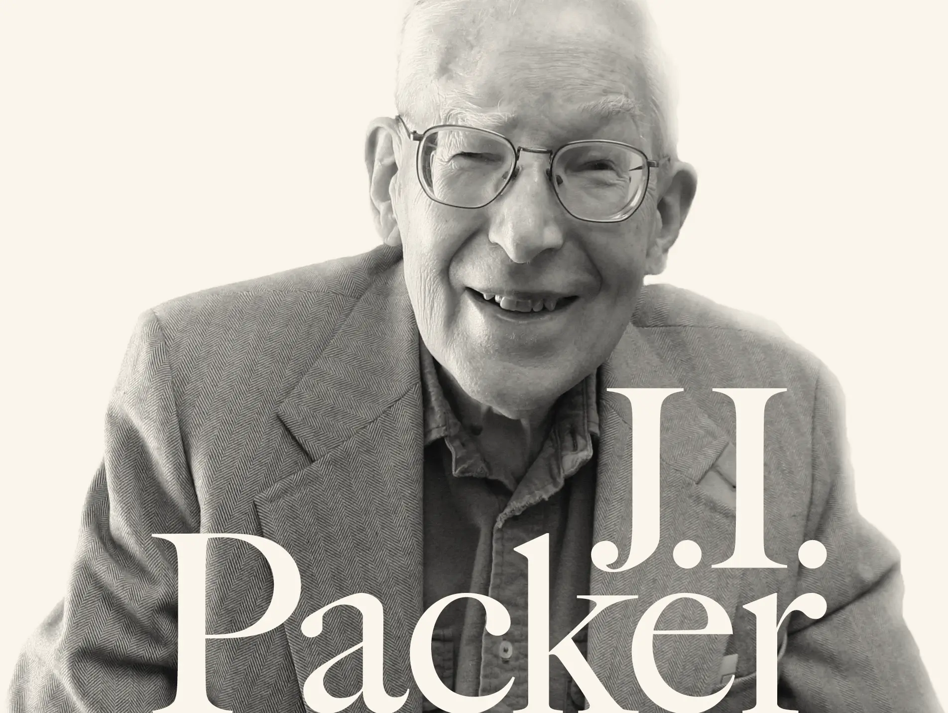 A black & white photo of a smiling J.I. Packer